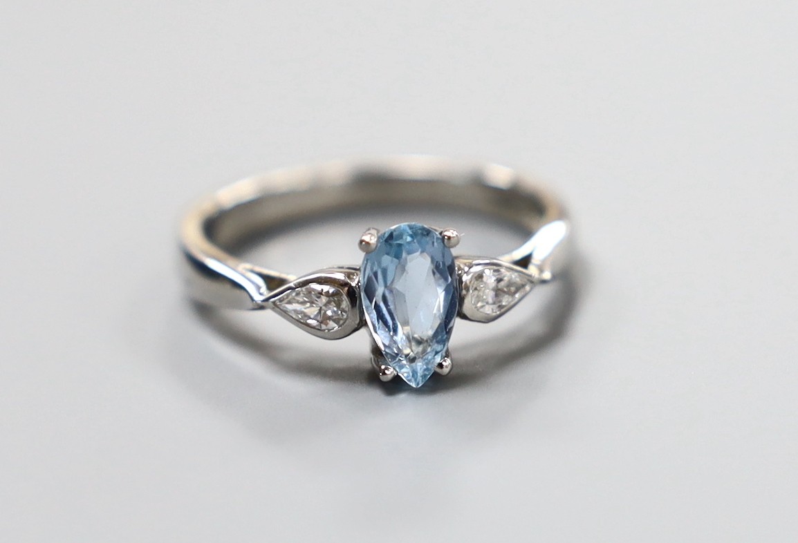 A modern platinum, pear cut aquamarine and two stone pear cut diamond set dress ring, size N, gross weight 5.3 grams